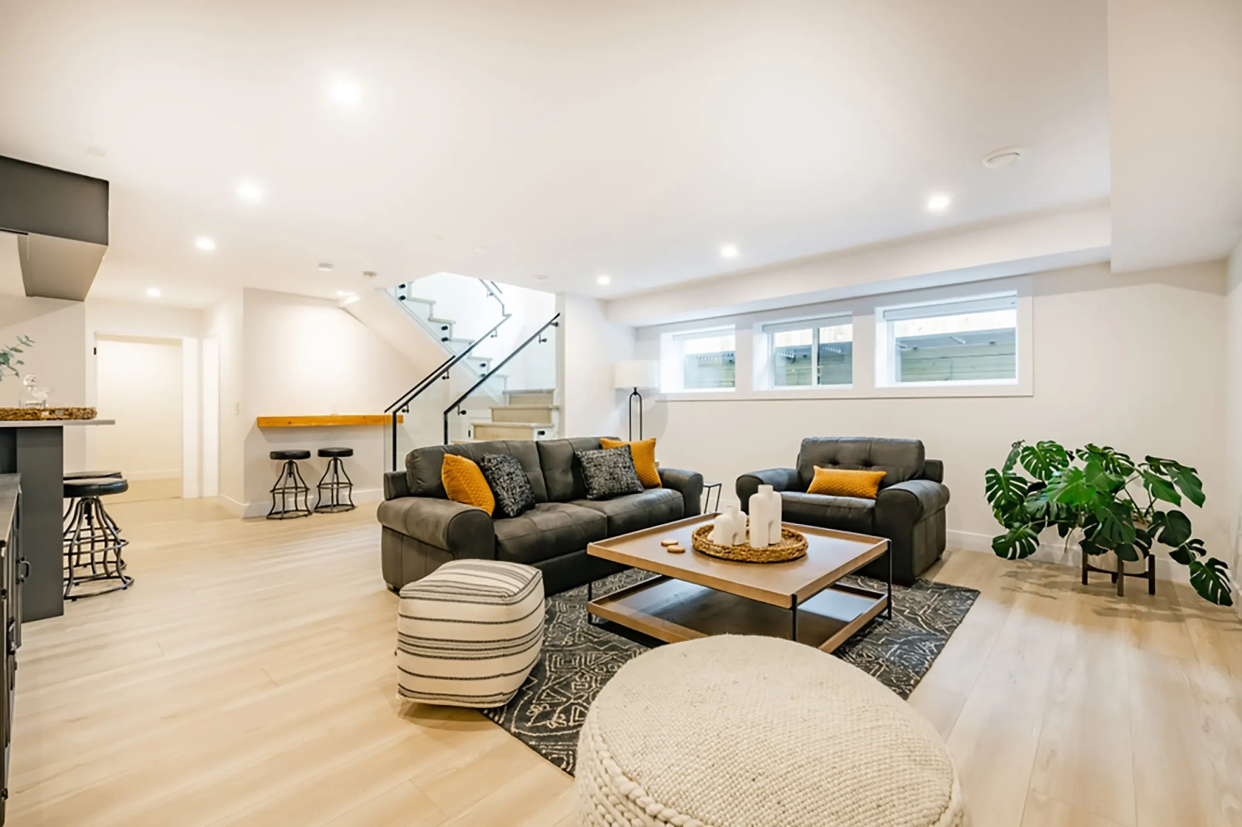 Bright finished Prime Craft basement lounge with open stairs and flexible gathering space