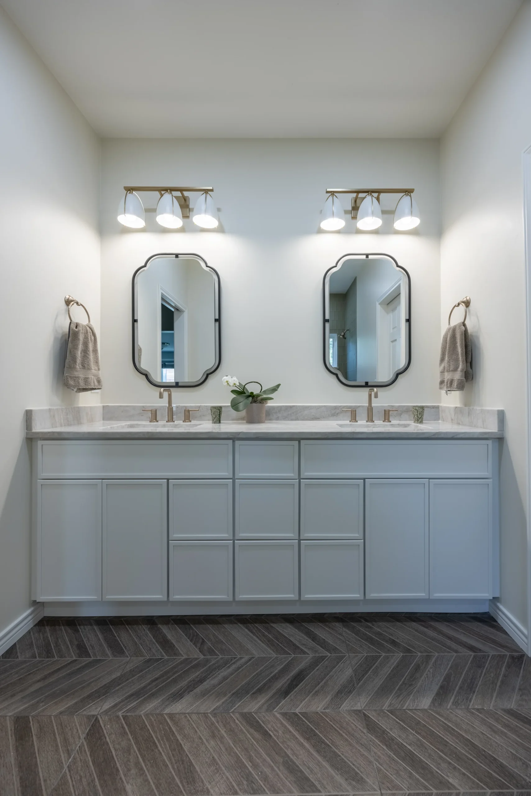 Long double vanity, freestanding tub, and glass shower in a Jamaica bathroom remodel