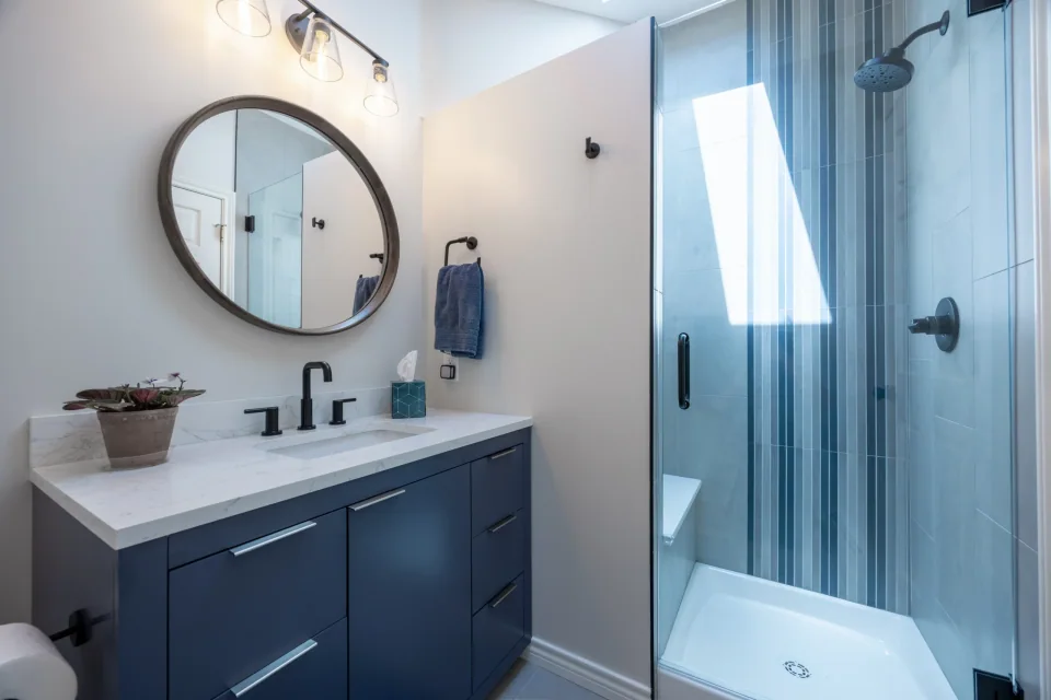 Prime Craft design-build detail featuring a tailored blue vanity and bathroom finishes