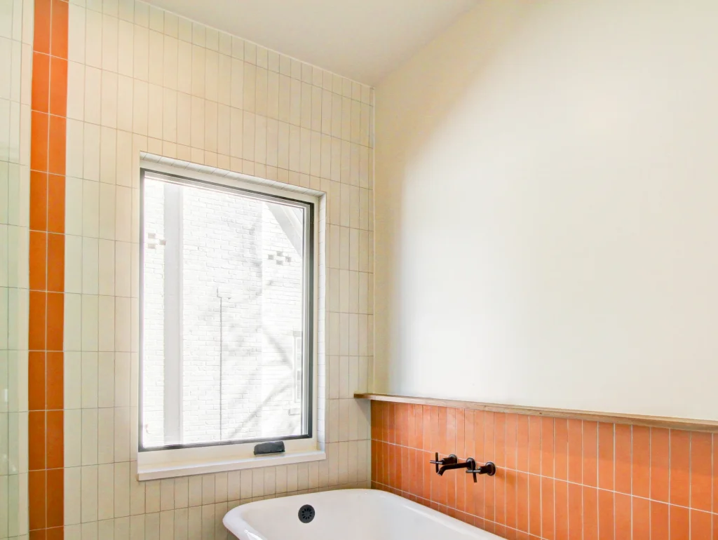 Handmade cement tile and walnut trim in the completed Queens Village bathroom