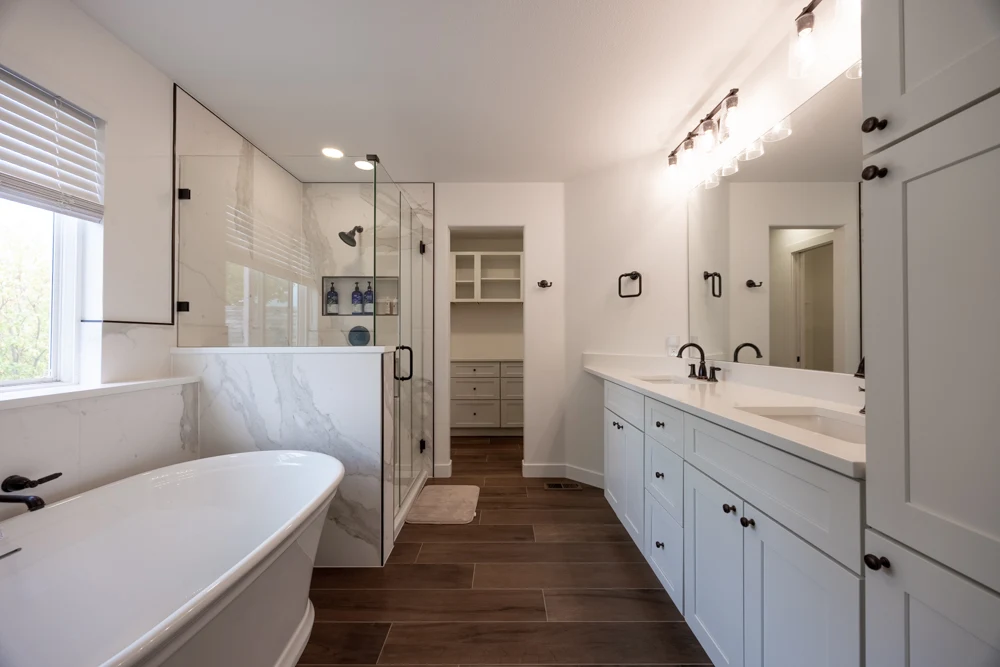 Completed Valley Stream primary bathroom with freestanding tub, glass shower, and double vanity